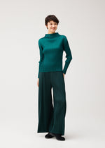 A model wears the PLEATS PLEASE ISSEY MIYAKE MONTHLY COLORS : OCTOBER monthly-colors-october-wide-leg-trousers-dark-green.