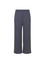 A product shot of the PLEATS PLEASE ISSEY MIYAKE COTTON DENIM trousers in navy blue.