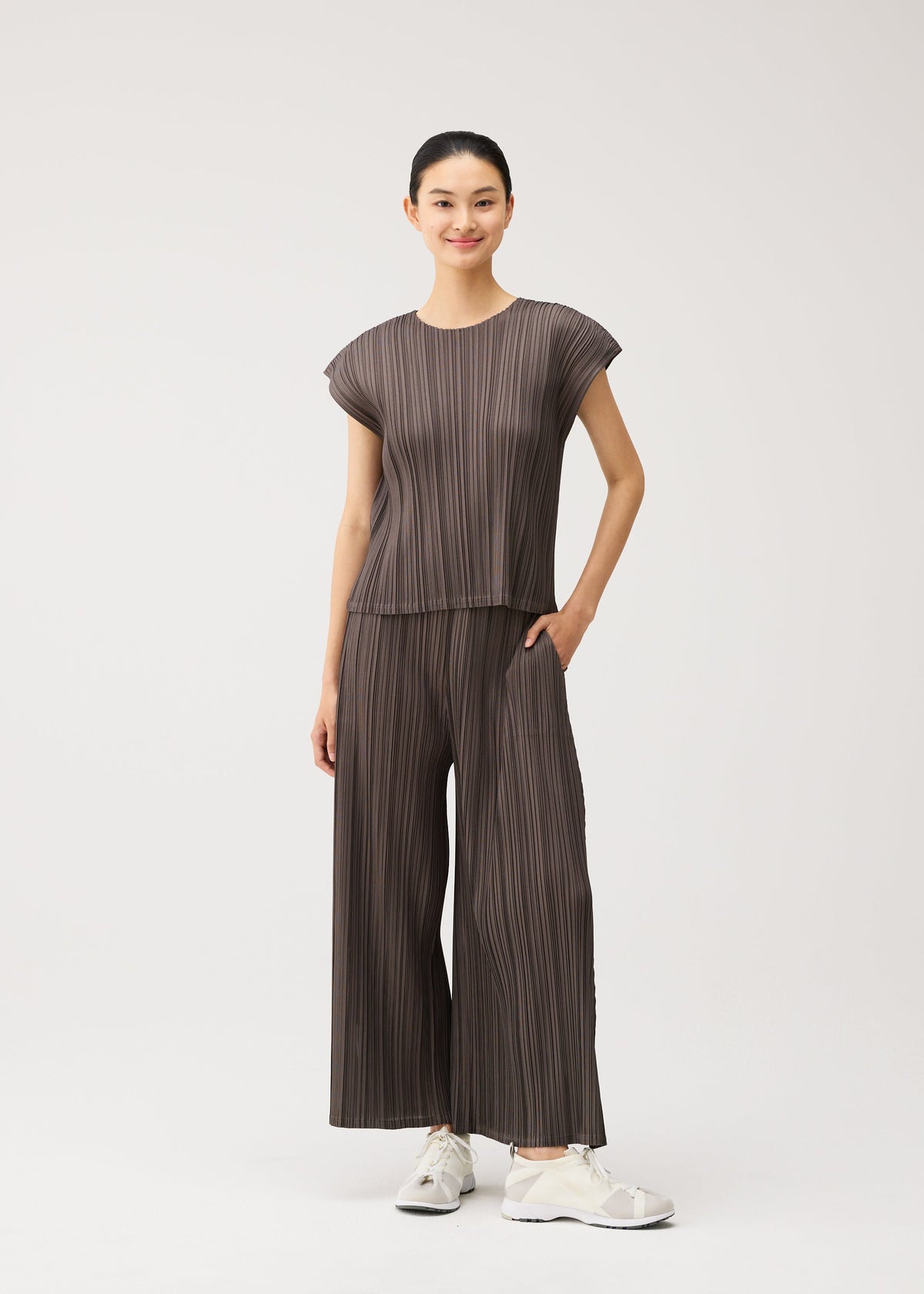 A model wears the PLEATS PLEASE ISSEY MIYAKE MELLOW PLEATS mellow-pleats-cropped-wide-leg-trousers-cerulean-blue.