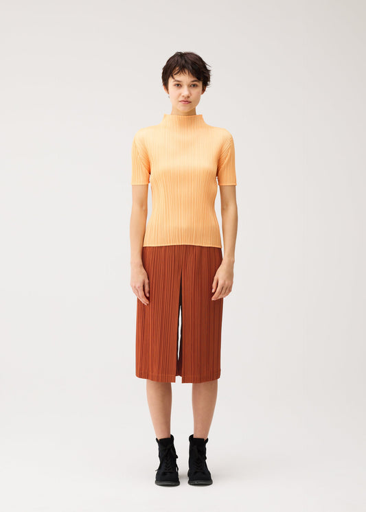 A model wears the PLEATS PLEASE ISSEY MIYAKE THICKER BOTTOMS 2 thicker-bottoms-2-trousers-magenta.