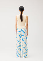 A model wears the PLEATS PLEASE ISSEY MIYAKE FOLD LINE fold-line-trousers-off-white.