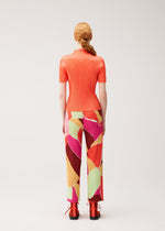A model wears the PLEATS PLEASE ISSEY MIYAKE SURPRISE! surprise-trousers-purple.