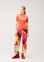 A model wears the PLEATS PLEASE ISSEY MIYAKE SURPRISE! surprise-trousers-purple.