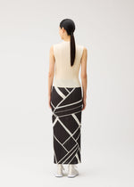 A model wears the PLEATS PLEASE ISSEY MIYAKE FOLD LINE fold-line-skirt-off-white.