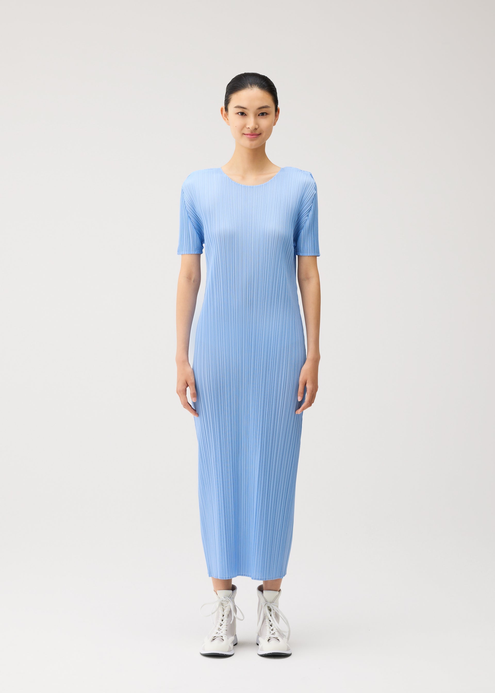 A model wears the PLEATS PLEASE ISSEY MIYAKE MONTHLY COLORS : AUGUST monthly-colors-august-dress-greyish-green.