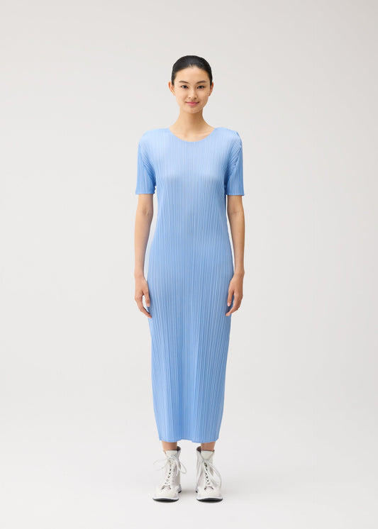 A model wears the PLEATS PLEASE ISSEY MIYAKE MONTHLY COLORS : AUGUST monthly-colors-august-dress-off-white.