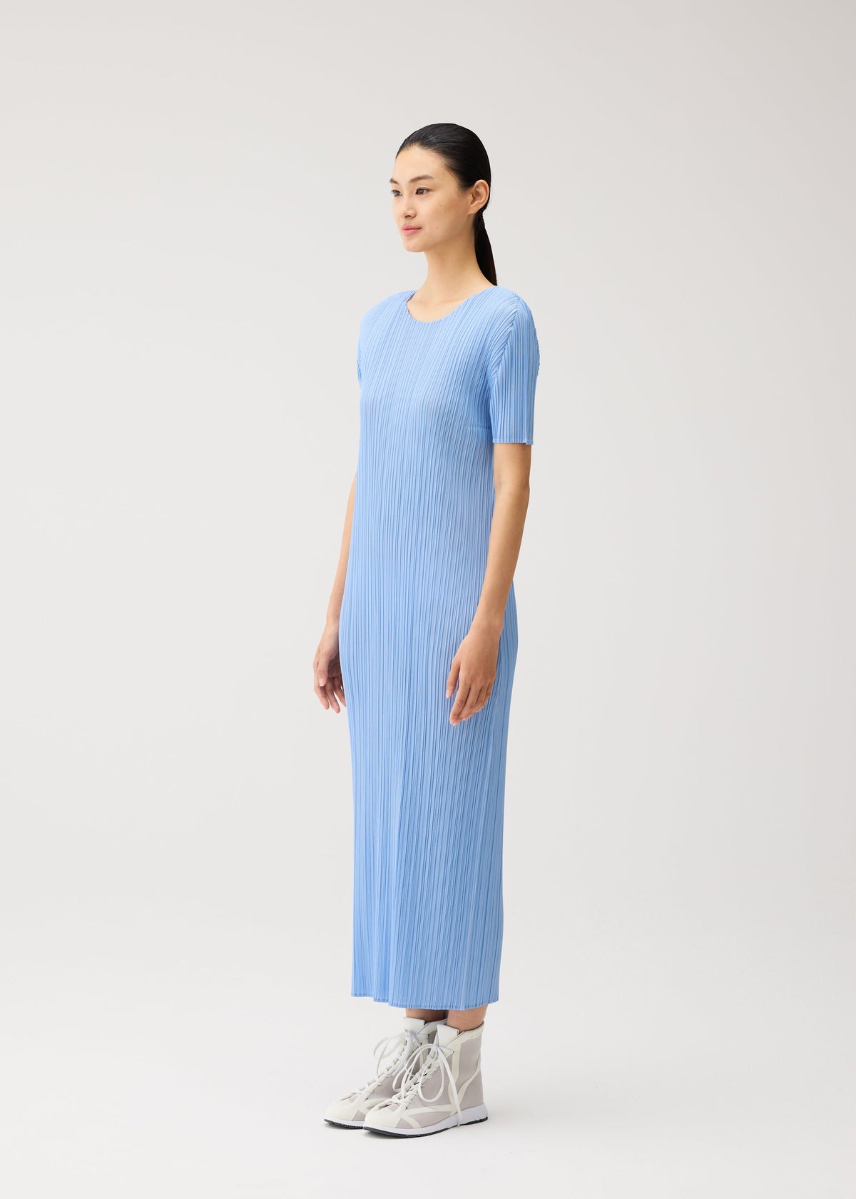 A model wears the PLEATS PLEASE ISSEY MIYAKE MONTHLY COLORS : AUGUST monthly-colors-august-dress-greyish-green.