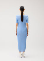A model wears the PLEATS PLEASE ISSEY MIYAKE MONTHLY COLORS : AUGUST monthly-colors-august-dress-greyish-green.