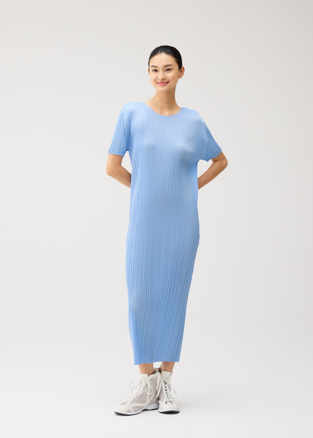A model wears the PLEATS PLEASE ISSEY MIYAKE MONTHLY COLORS : AUGUST monthly-colors-august-dress-greyish-green.