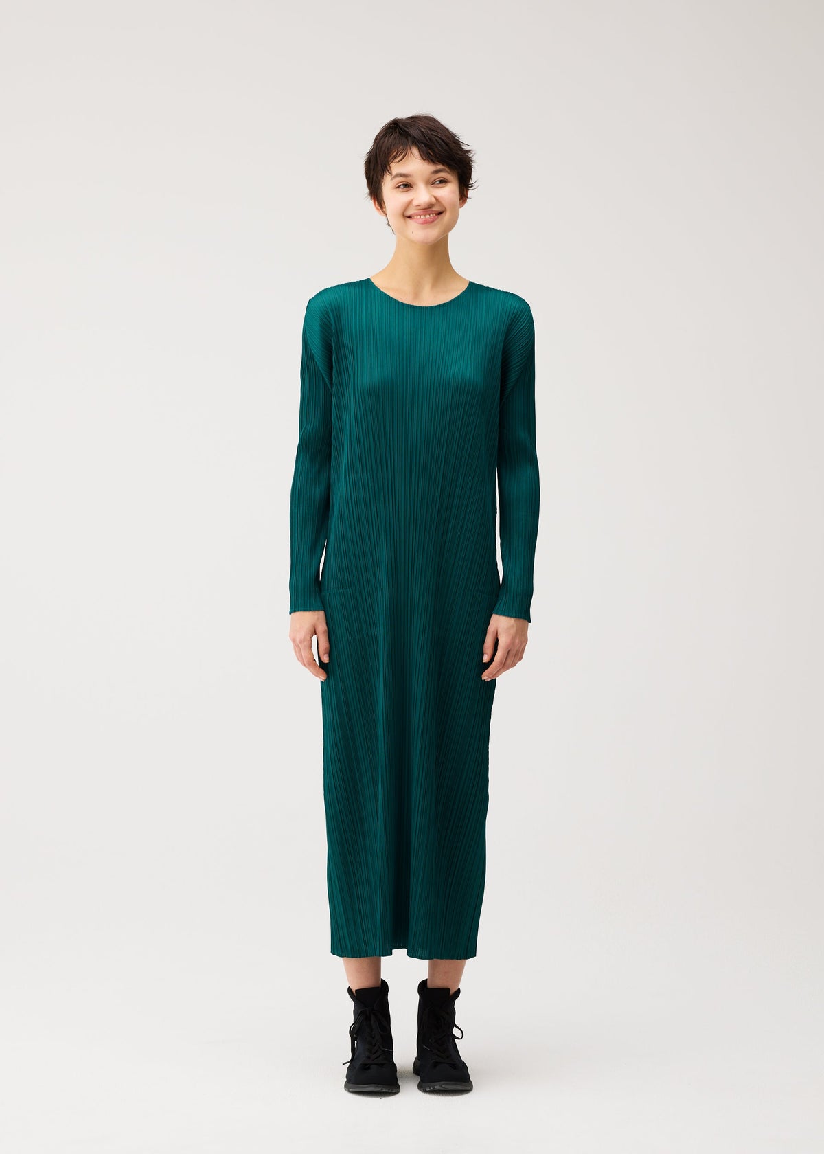 A model wears the PLEATS PLEASE ISSEY MIYAKE MONTHLY COLORS : OCTOBER monthly-colors-october-midi-dress-blue-green.