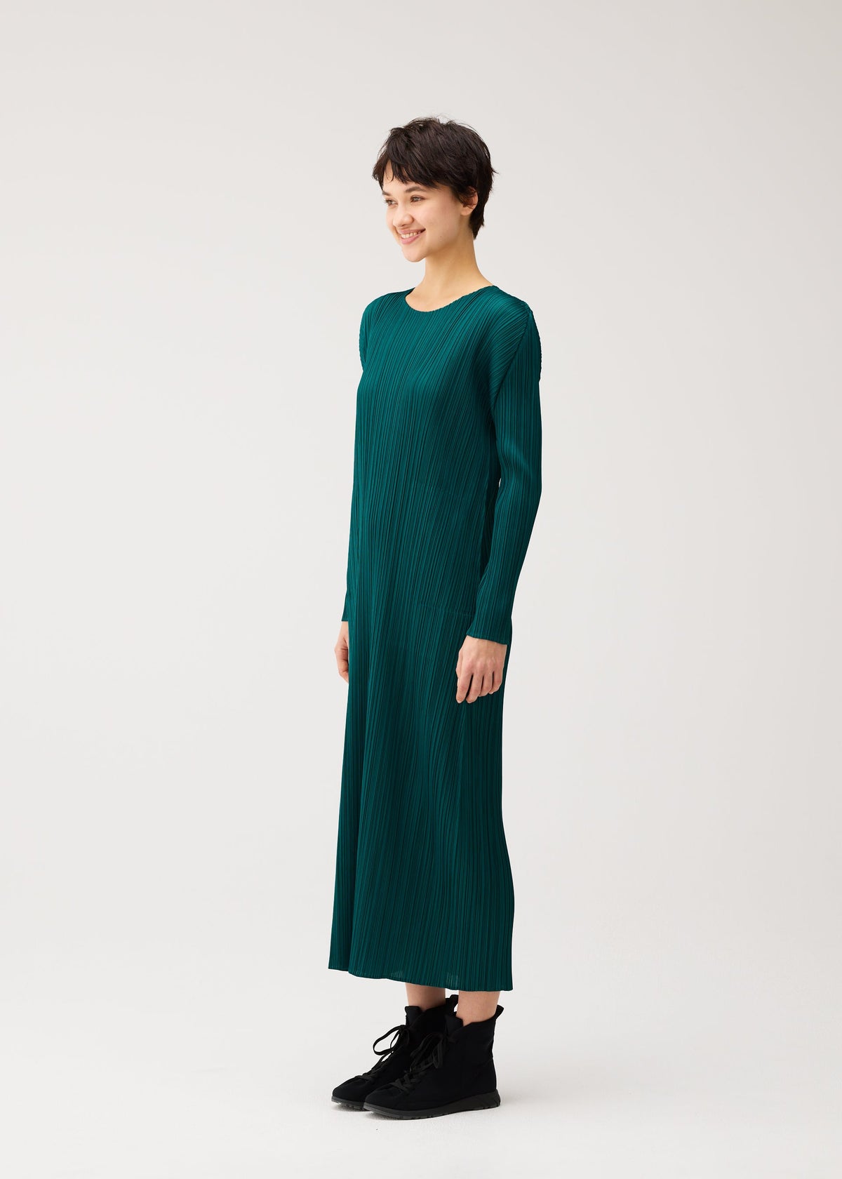 A model wears the PLEATS PLEASE ISSEY MIYAKE MONTHLY COLORS : OCTOBER monthly-colors-october-midi-dress-green.
