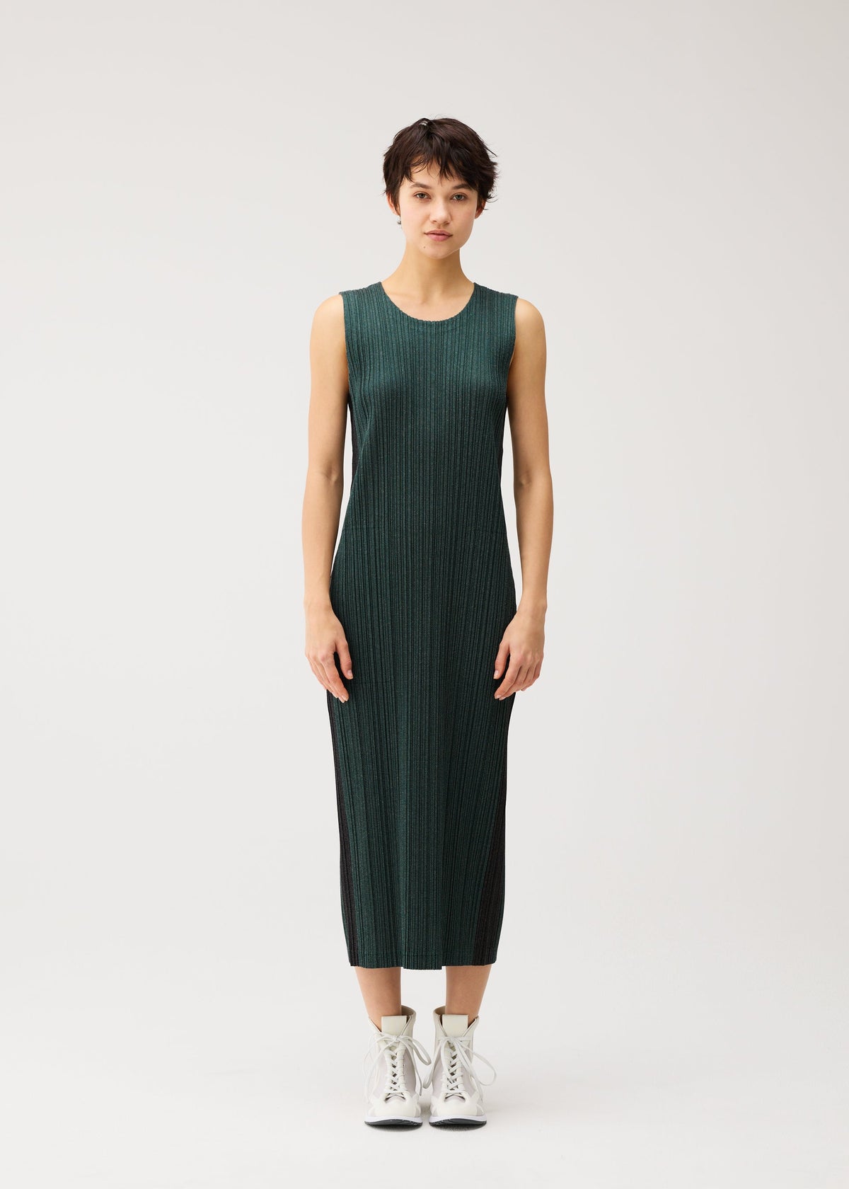 A model wears the PLEATS PLEASE ISSEY MIYAKE COTTON DENIM cotton-denim-dress-navy-blue.