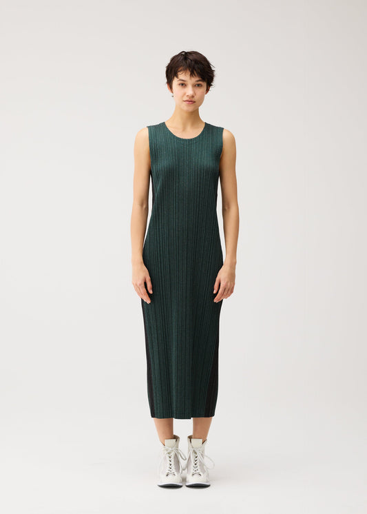 A model wears the PLEATS PLEASE ISSEY MIYAKE COTTON DENIM cotton-denim-dress-navy-blue.