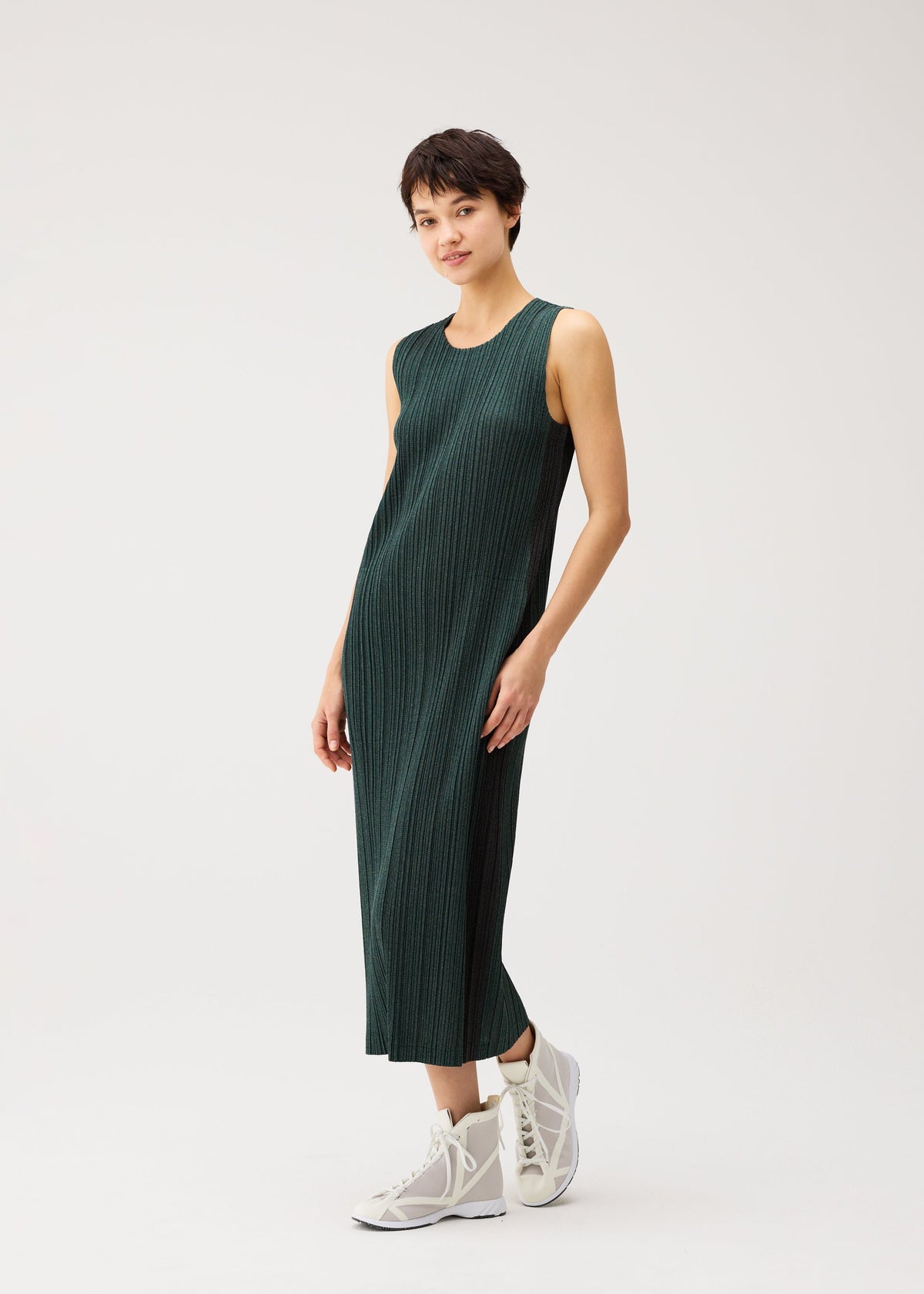 A model wears the PLEATS PLEASE ISSEY MIYAKE COTTON DENIM cotton-denim-dress-navy-blue.