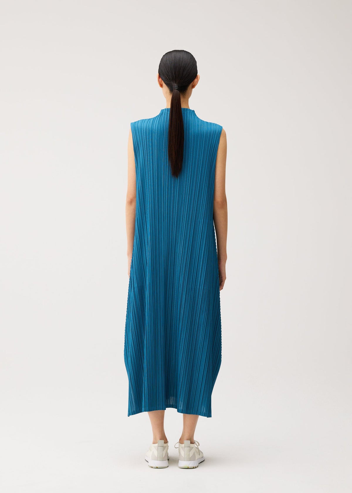 A model wears the PLEATS PLEASE ISSEY MIYAKE MELLOW PLEATS mellow-pleats-sleeveless-dress-black.