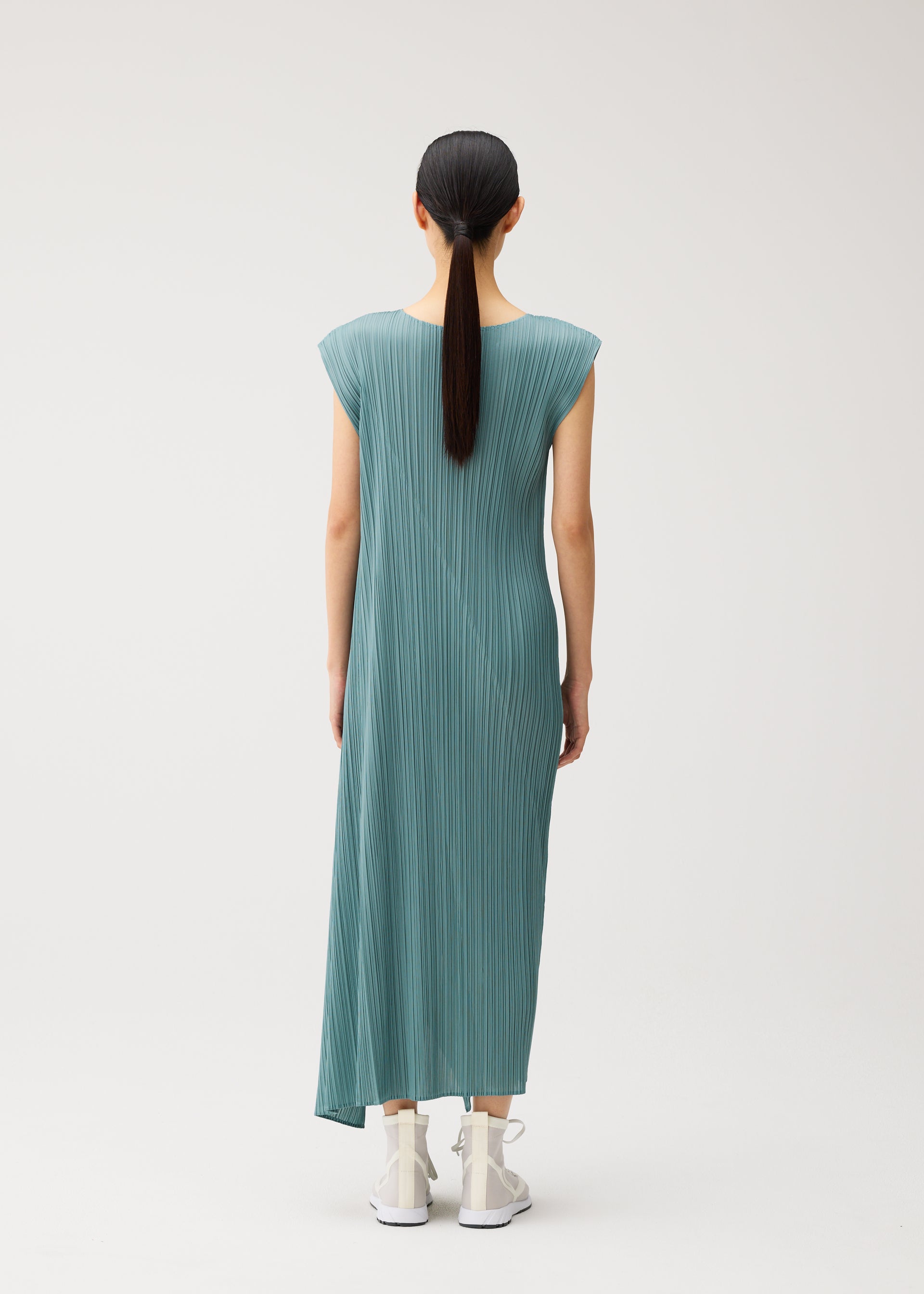 A model wears the PLEATS PLEASE ISSEY MIYAKE FOLD fold-dress-mint-green.