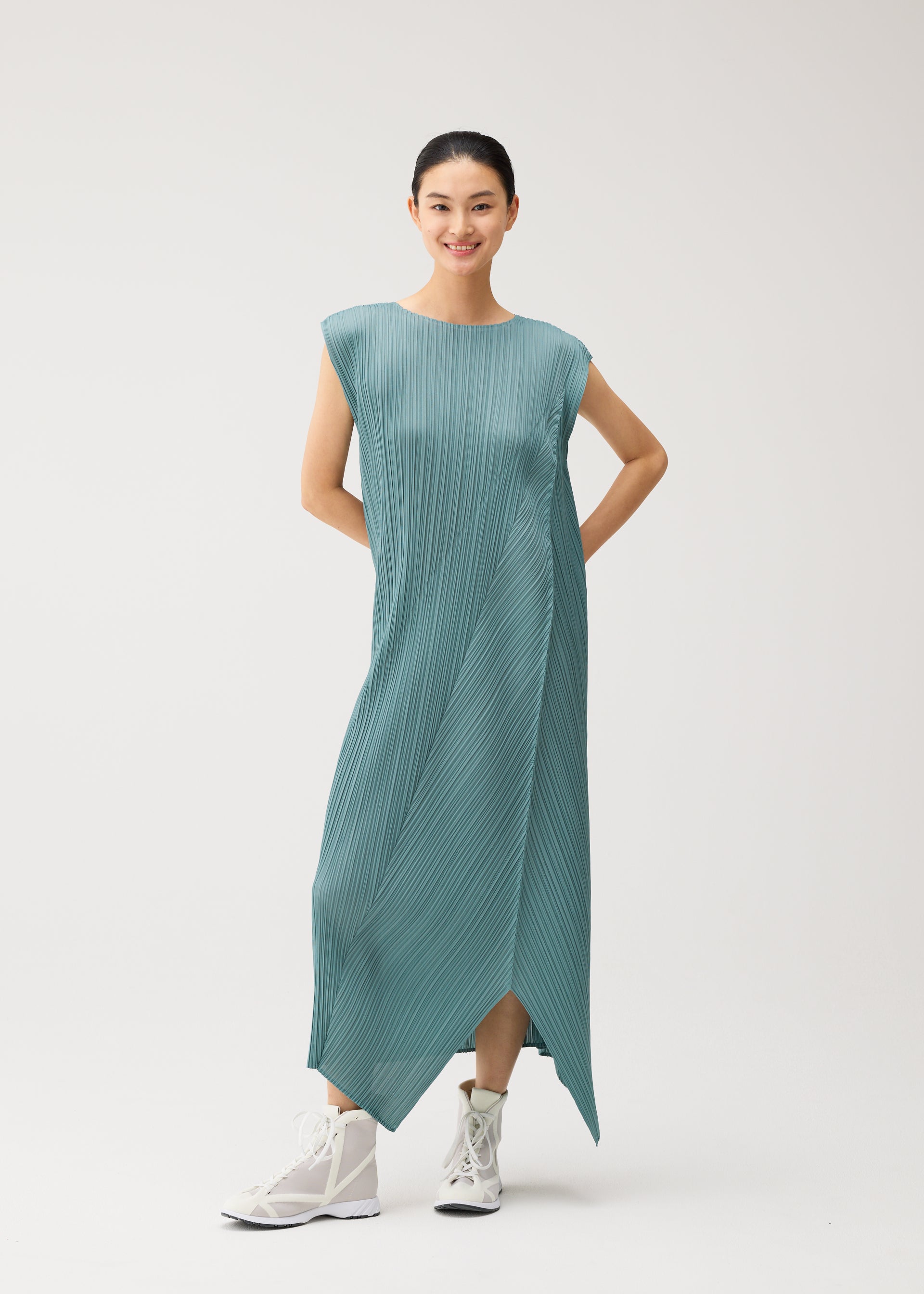 A model wears the PLEATS PLEASE ISSEY MIYAKE FOLD fold-dress-mint-green.