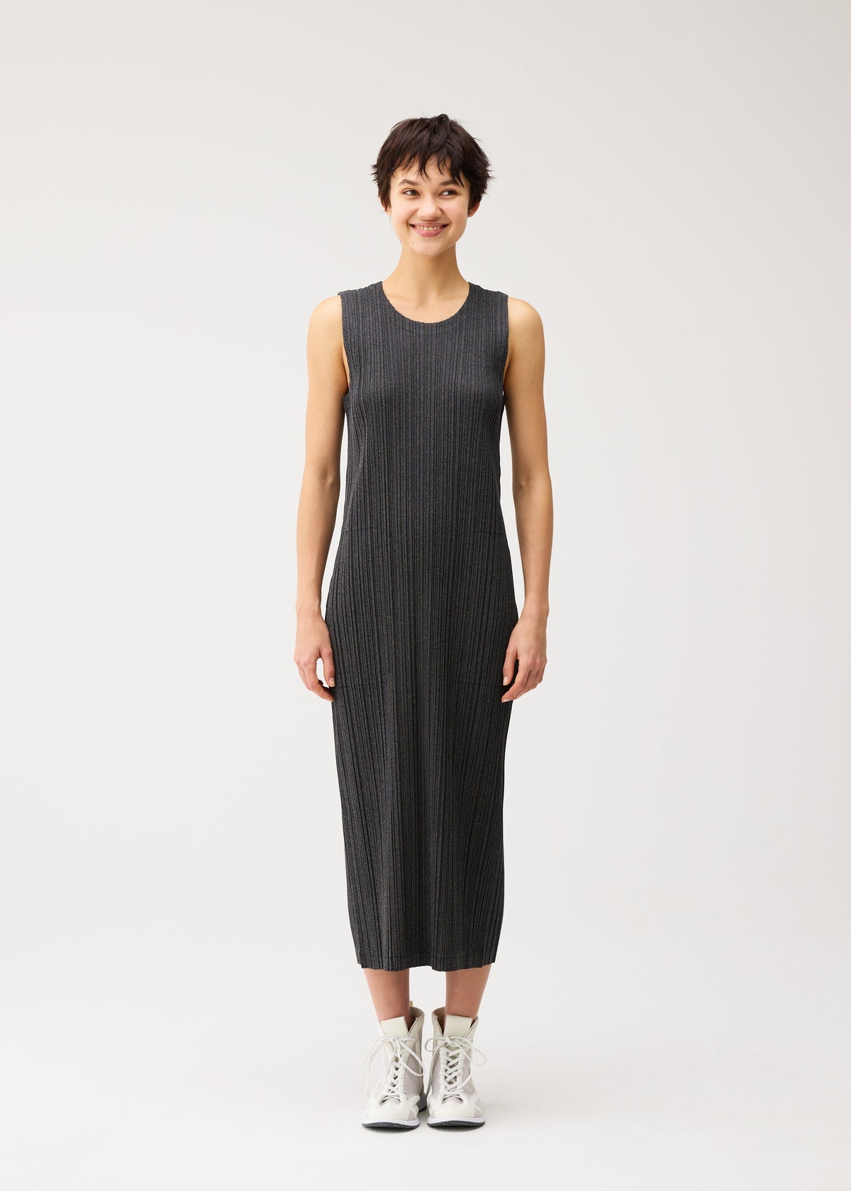A model wears the PLEATS PLEASE ISSEY MIYAKE COTTON DENIM BLACK cotton-denim-black-dress-black.