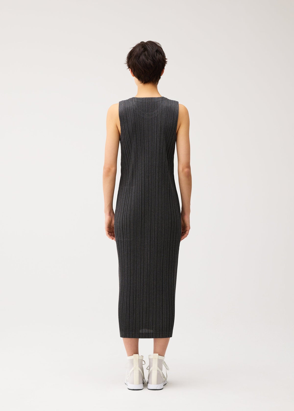 A model wears the PLEATS PLEASE ISSEY MIYAKE COTTON DENIM BLACK cotton-denim-black-dress-black.