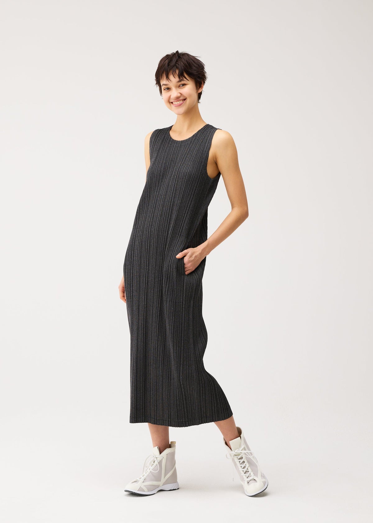 A model wears the PLEATS PLEASE ISSEY MIYAKE COTTON DENIM BLACK cotton-denim-black-dress-black.