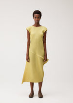 A model wears the PLEATS PLEASE ISSEY MIYAKE LEAP leap-dress-pale-yellow.