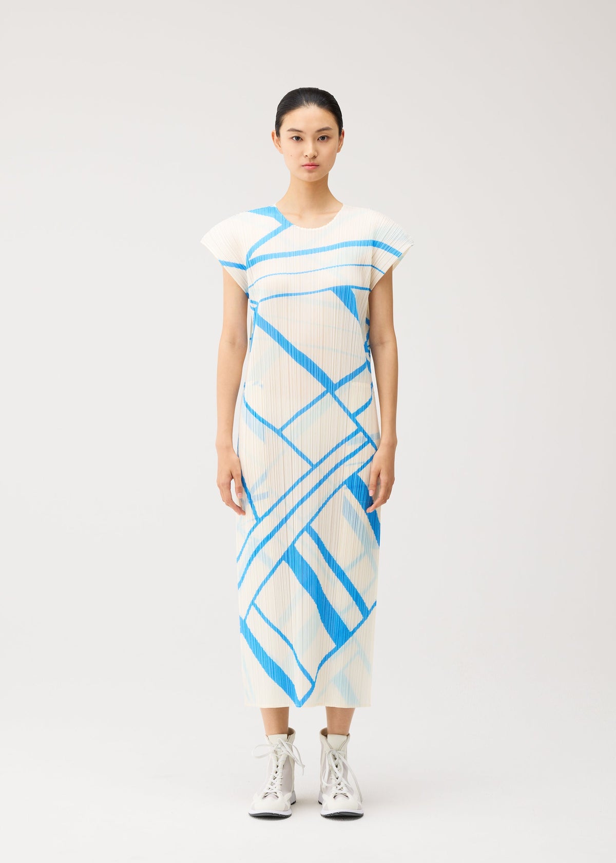 A model wears the PLEATS PLEASE ISSEY MIYAKE FOLD LINE fold-line-dress-off-white.