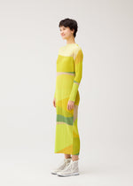 A model wears the PLEATS PLEASE ISSEY MIYAKE ORBIT orbit-dress-green.