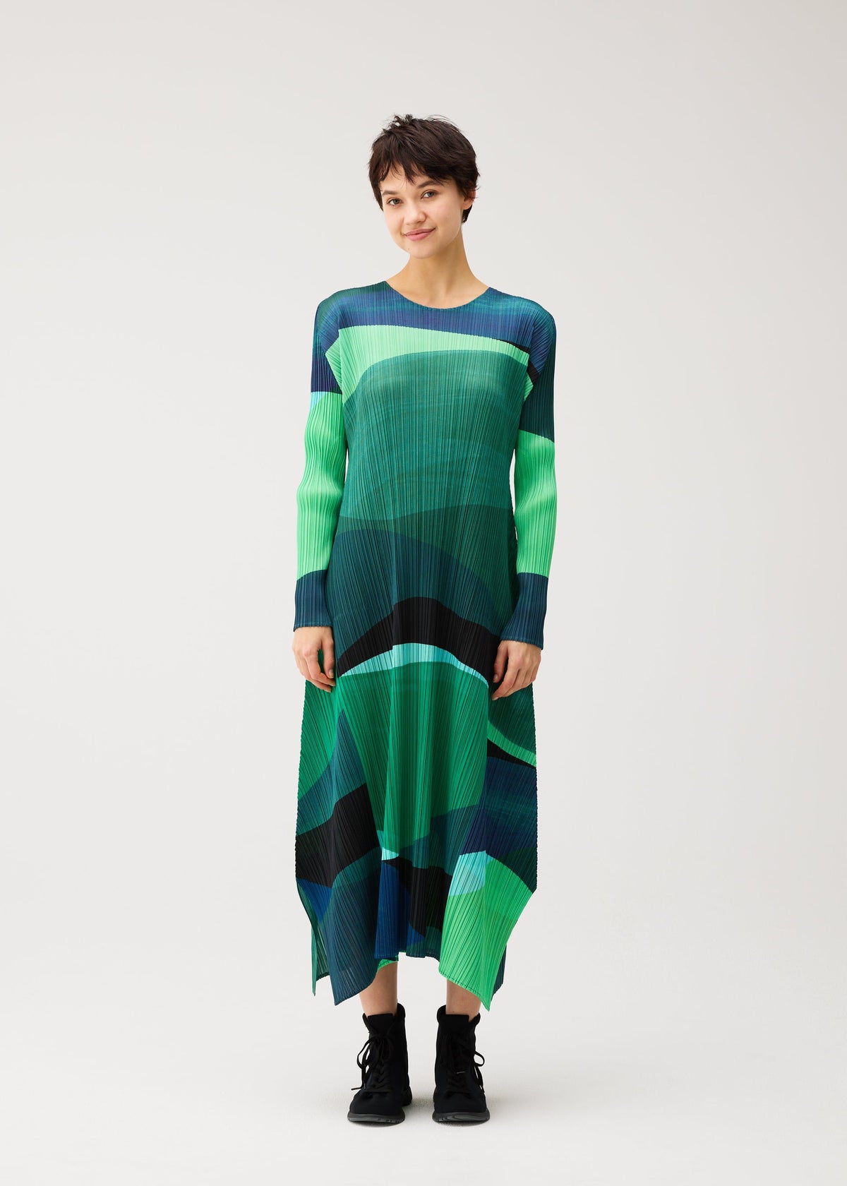 A model wears the PLEATS PLEASE ISSEY MIYAKE ORBIT orbit-a-line-dress-yellow.