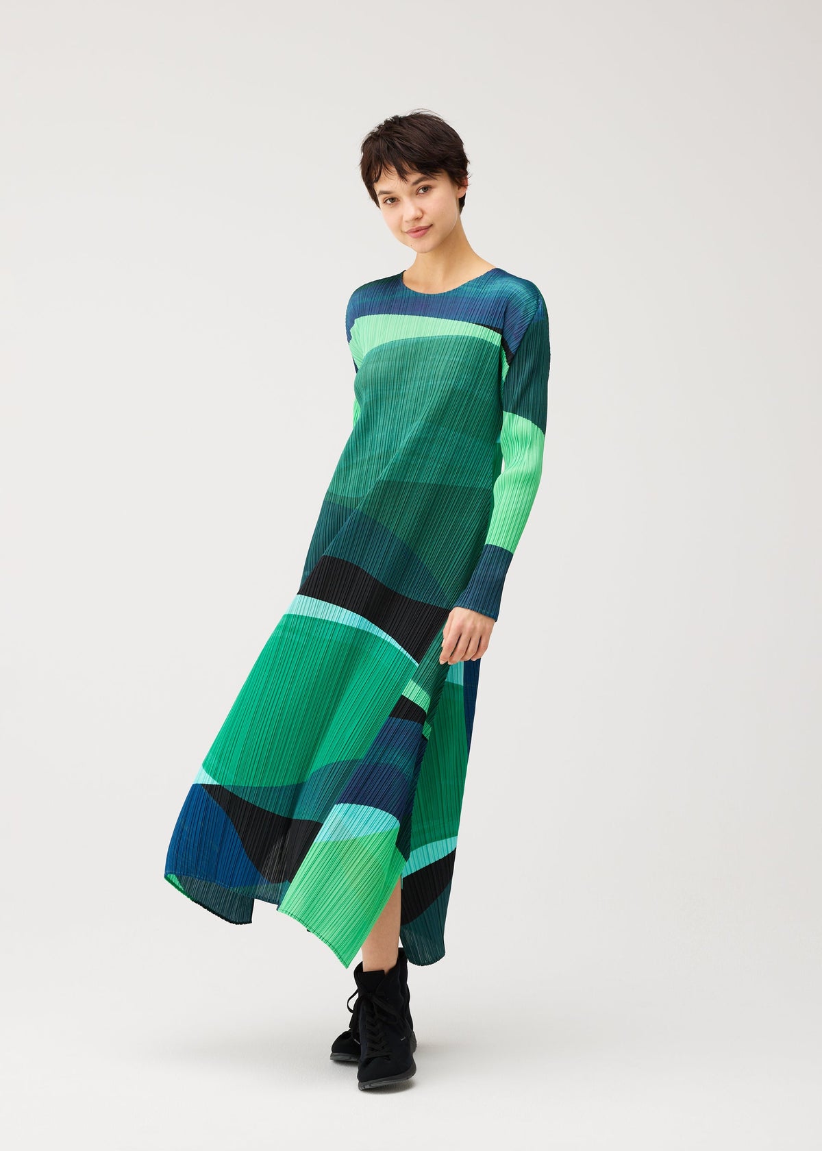 A model wears the PLEATS PLEASE ISSEY MIYAKE ORBIT orbit-a-line-dress-yellow.