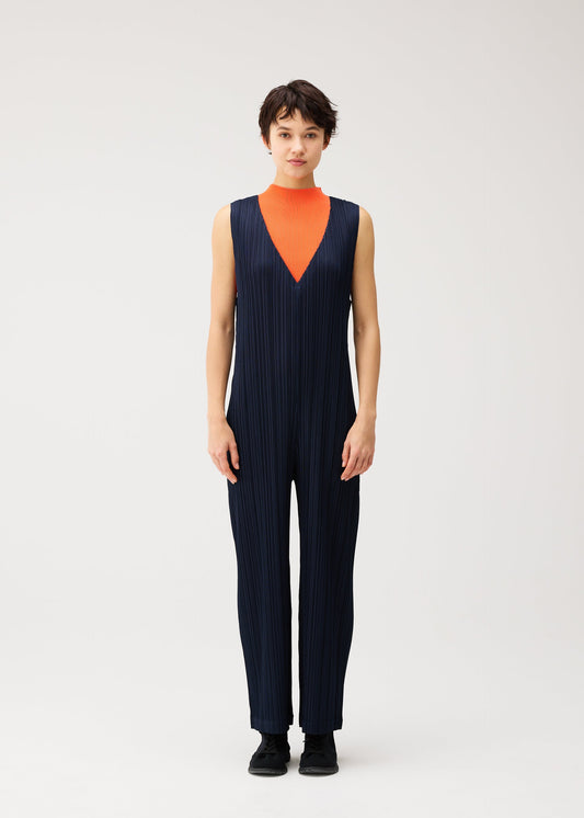 A model wears the PLEATS PLEASE ISSEY MIYAKE THICKER BOTTOMS 2 thicker-bottoms-2-jumpsuit-navy.