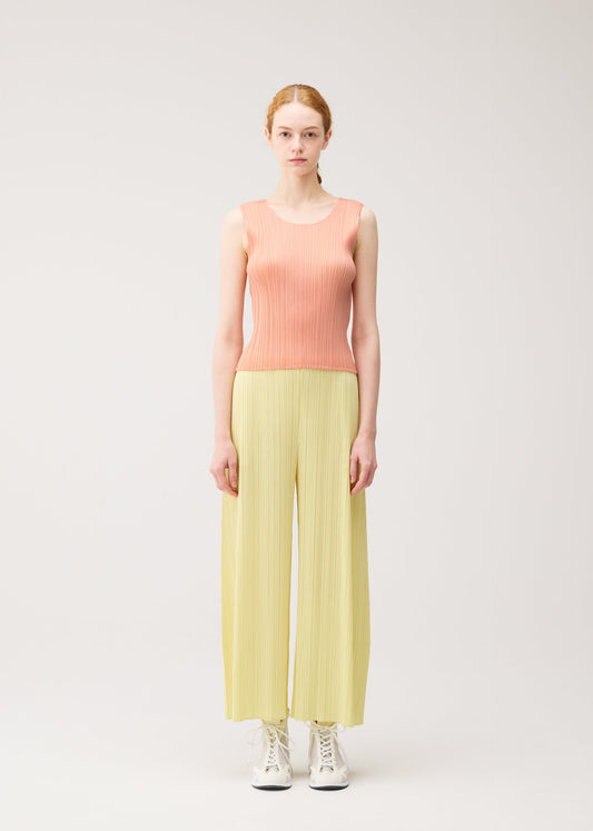 A model wears the PLEATS PLEASE ISSEY MIYAKE MONTHLY COLORS : JULY top.