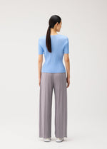 A model wears the PLEATS PLEASE ISSEY MIYAKE MONTHLY COLORS : AUGUST monthly-colors-august-v-neck-top-light-blue.