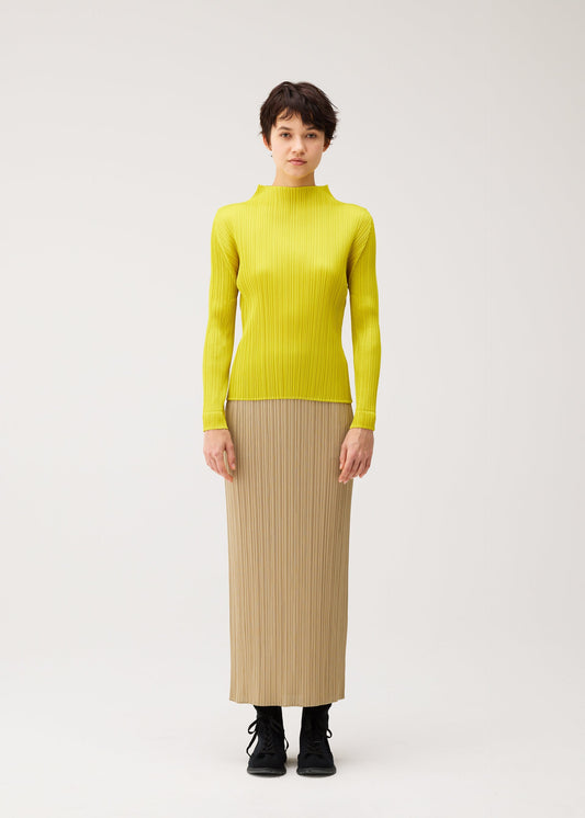 A model wears the PLEATS PLEASE ISSEY MIYAKE MONTHLY COLORS : OCTOBER monthly-colors-october-long-sleeved-top-yellow-ochre.