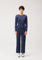 A model wears the PLEATS PLEASE ISSEY MIYAKE COTTON DENIM cotton-denim-top-navy-blue.