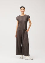 A model wears the PLEATS PLEASE ISSEY MIYAKE MELLOW PLEATS mellow-pleats-cap-sleeved-top-charcoal.