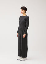 A model wears the PLEATS PLEASE ISSEY MIYAKE COTTON DENIM BLACK cotton-denim-black-top-black.