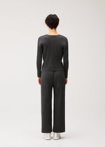 A model wears the PLEATS PLEASE ISSEY MIYAKE COTTON DENIM BLACK cotton-denim-black-top-black.