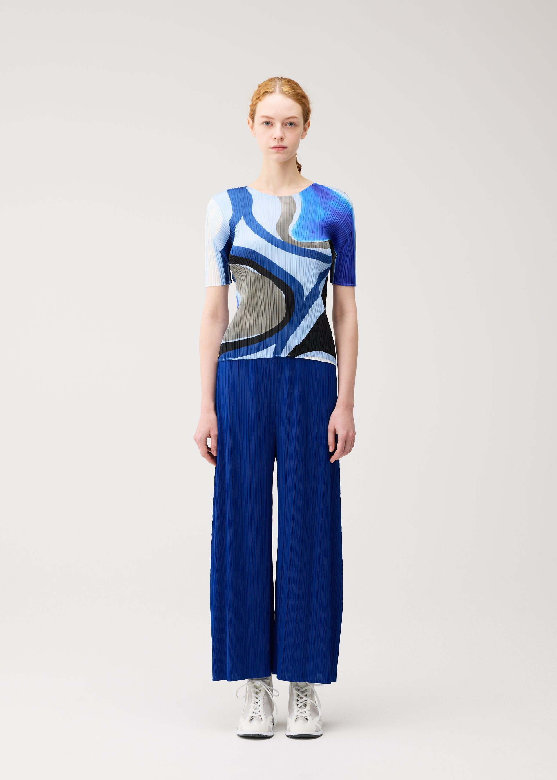 A model wears the PLEATS PLEASE ISSEY MIYAKE ROLL top.