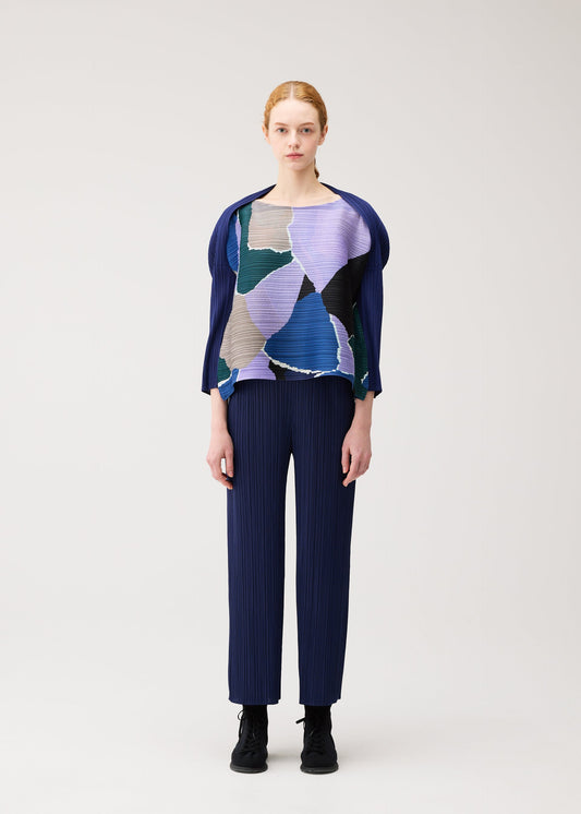 A model wears the PLEATS PLEASE ISSEY MIYAKE SURPRISE! surprise-top-orange-1.