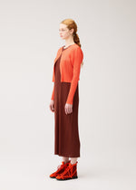 A model wears the PLEATS PLEASE ISSEY MIYAKE MONTHLY COLORS : SEPTEMBER monthly-colors-september-cardigan-red-brown.
