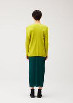 A model wears the PLEATS PLEASE ISSEY MIYAKE MONTHLY COLORS : OCTOBER monthly-colors-october-cardigan-dark-green.