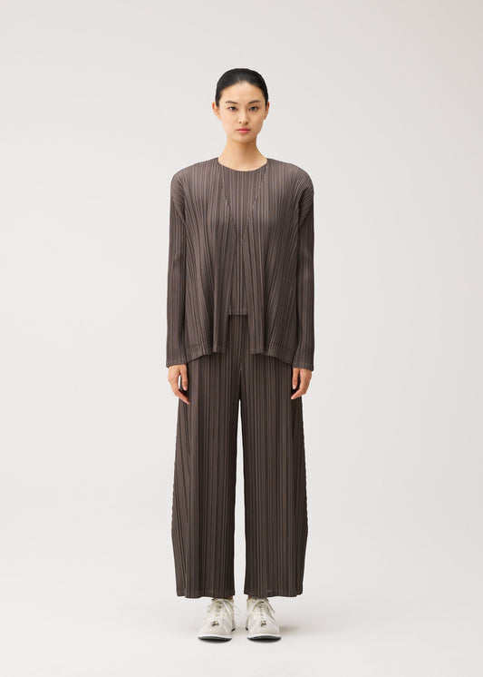 A model wears the PLEATS PLEASE ISSEY MIYAKE MELLOW PLEATS mellow-pleats-cardigan-black.