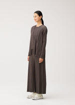 A model wears the PLEATS PLEASE ISSEY MIYAKE MELLOW PLEATS mellow-pleats-cardigan-black.