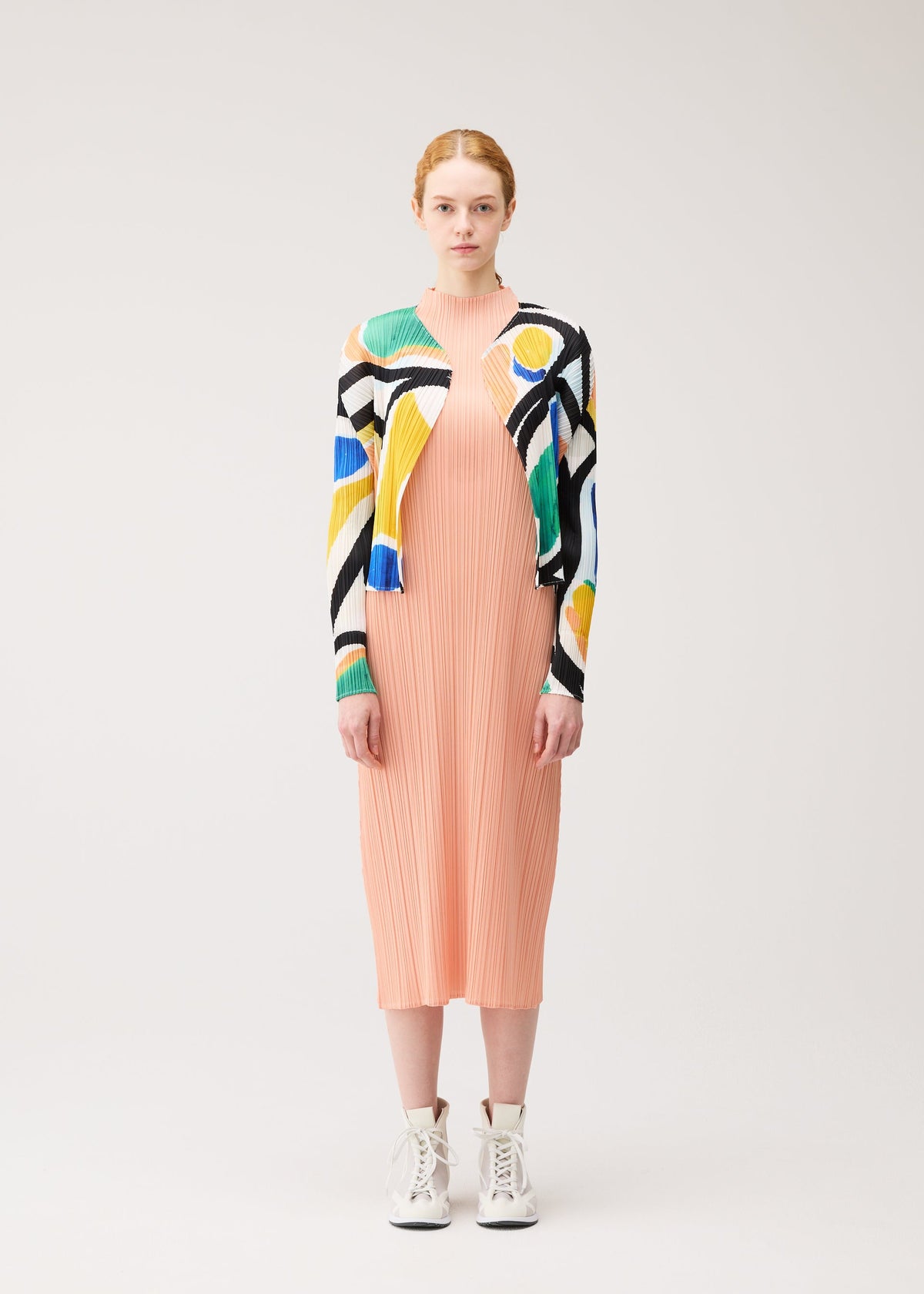 A model wears the PLEATS PLEASE ISSEY MIYAKE ROLL cardigan.