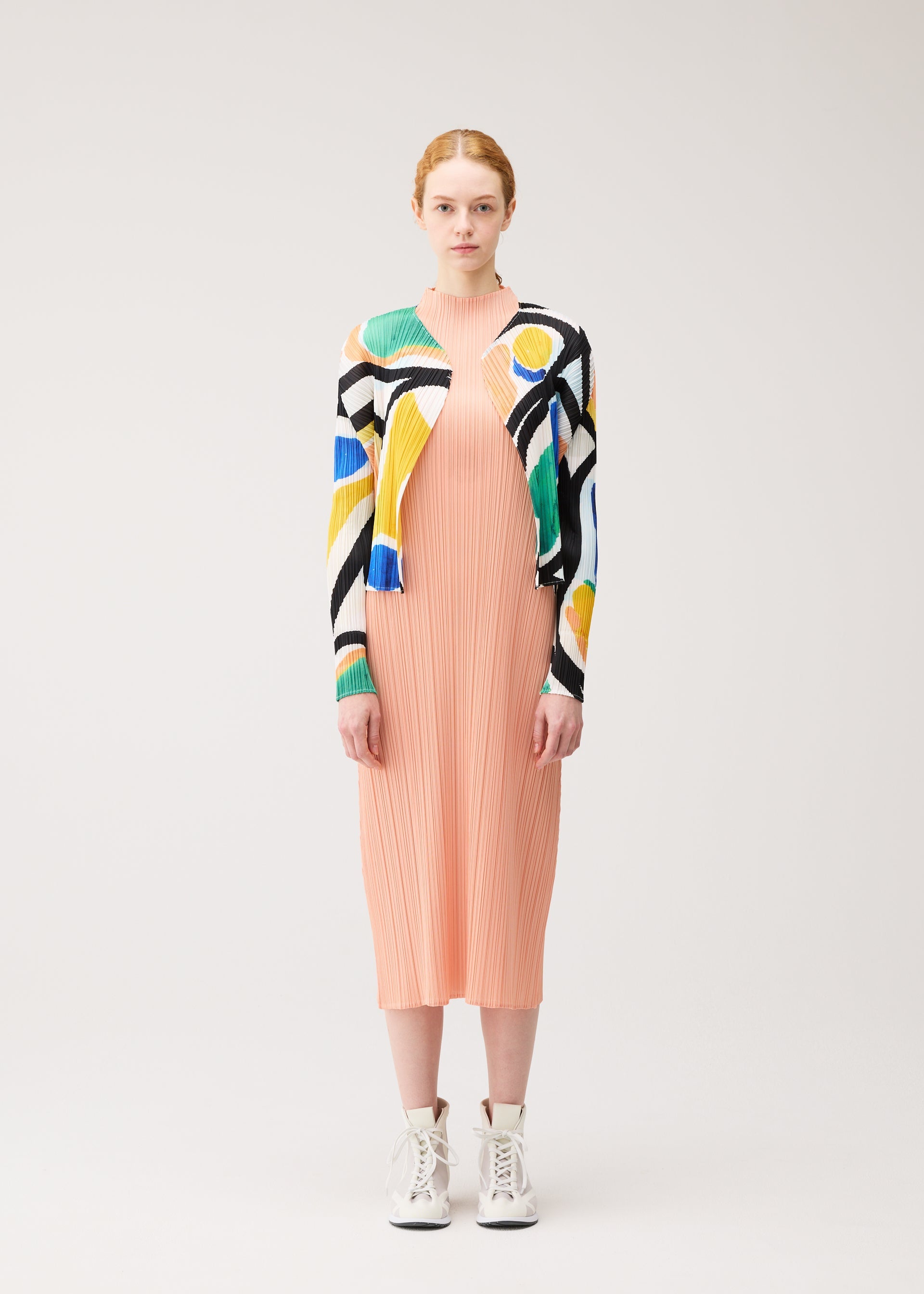 A model wears the PLEATS PLEASE ISSEY MIYAKE ROLL cardigan.
