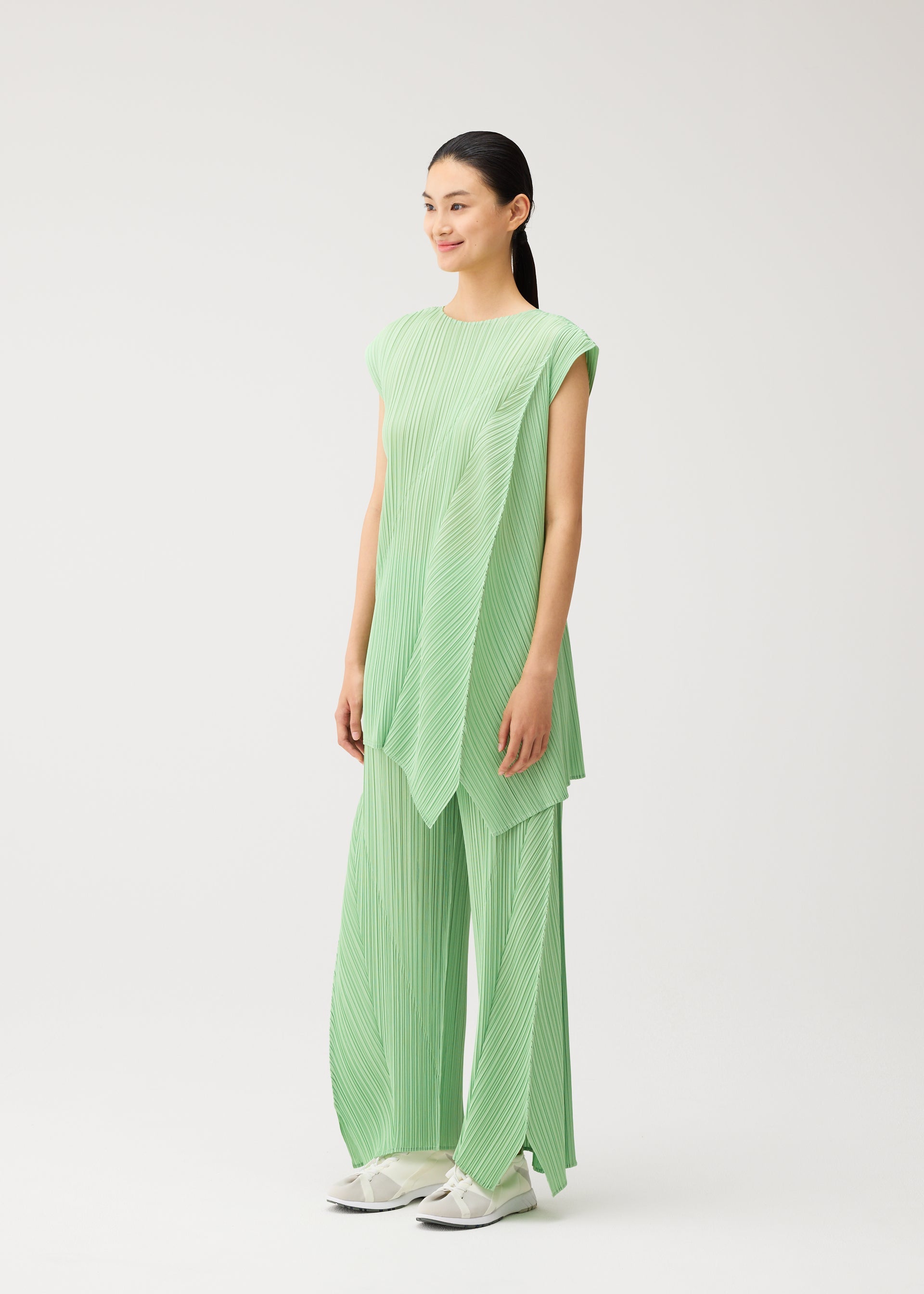 A model wears the PLEATS PLEASE ISSEY MIYAKE FOLD fold-tunic-black.