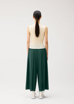 A model wears the PLEATS PLEASE ISSEY MIYAKE A-POC BOTTOMS a-poc-bottoms-trousers-flared-tapered-button-black.