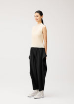 A model wears the PLEATS PLEASE ISSEY MIYAKE A-POC BOTTOMS a-poc-bottoms-side-drape-trousers-black.