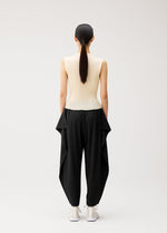 A model wears the PLEATS PLEASE ISSEY MIYAKE A-POC BOTTOMS a-poc-bottoms-side-drape-trousers-black.