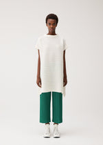 A model wears the PLEATS PLEASE ISSEY MIYAKE PAPER BOUNCE KNIT top.